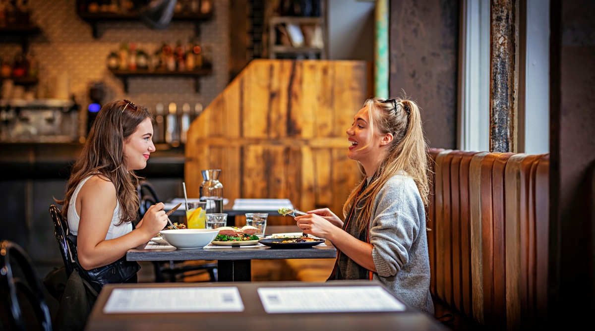 Two friends sharing a meal together in a restaurant
