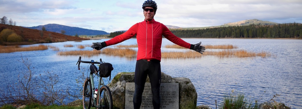 Cyclist with loch in background