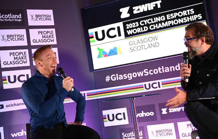 Man being interviewed in front of a press board