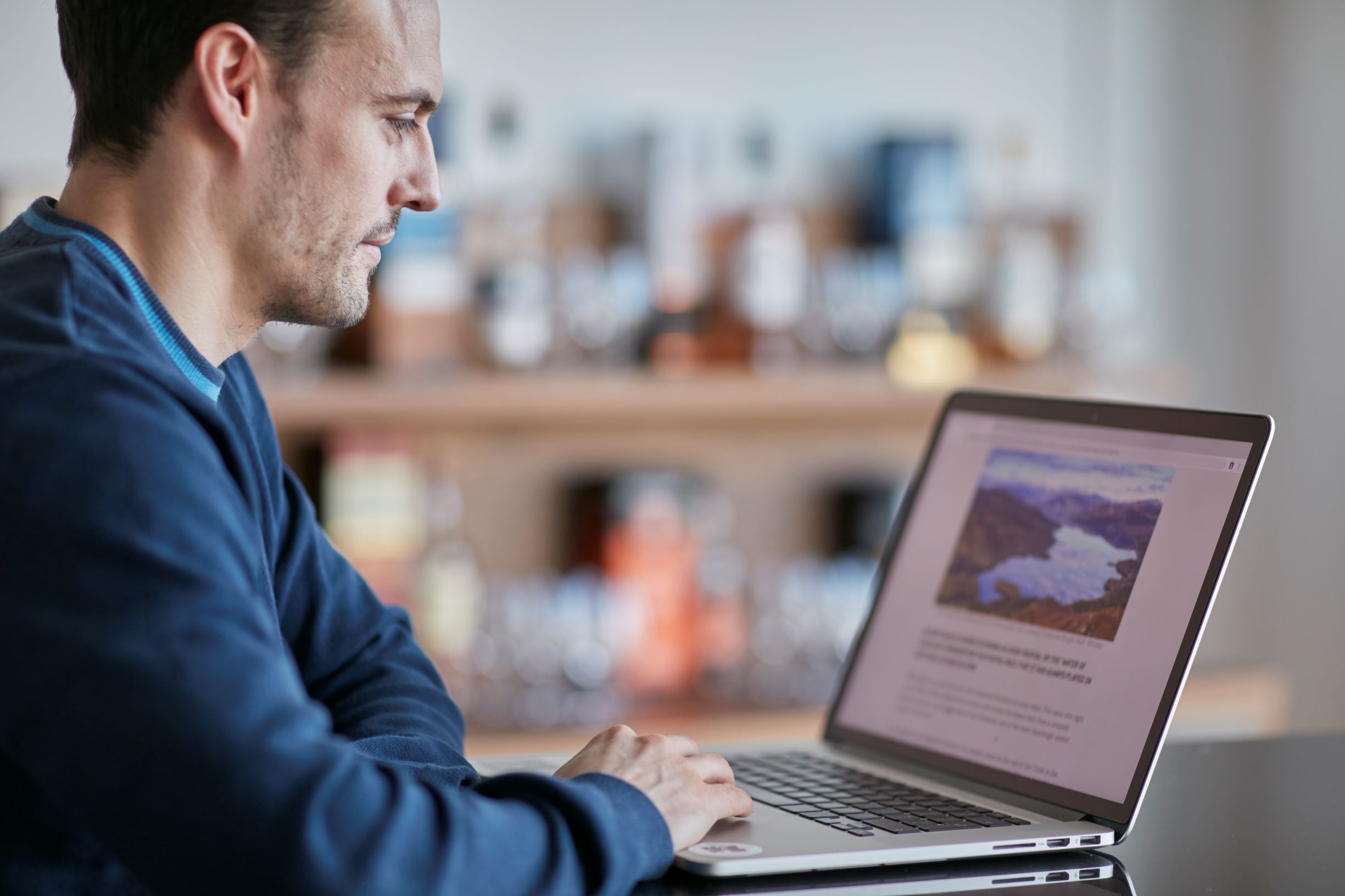 A man works behind his laptop.