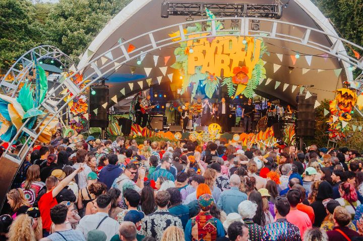 Crowd and band on stage at a festival