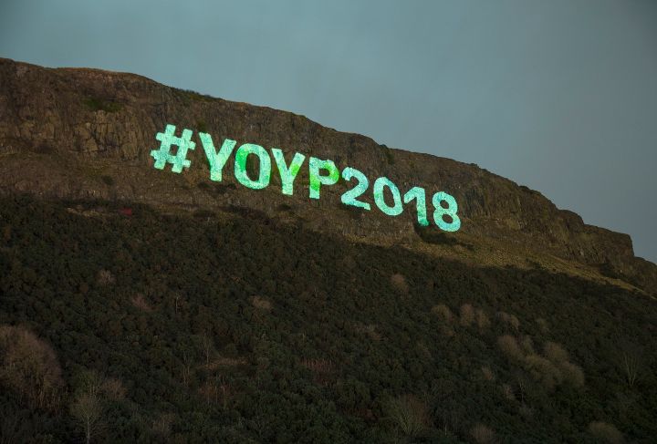 Year of Young People 2018 hashtag projected onto Salisbury Crags at the Torchlight Procession in Edinburgh