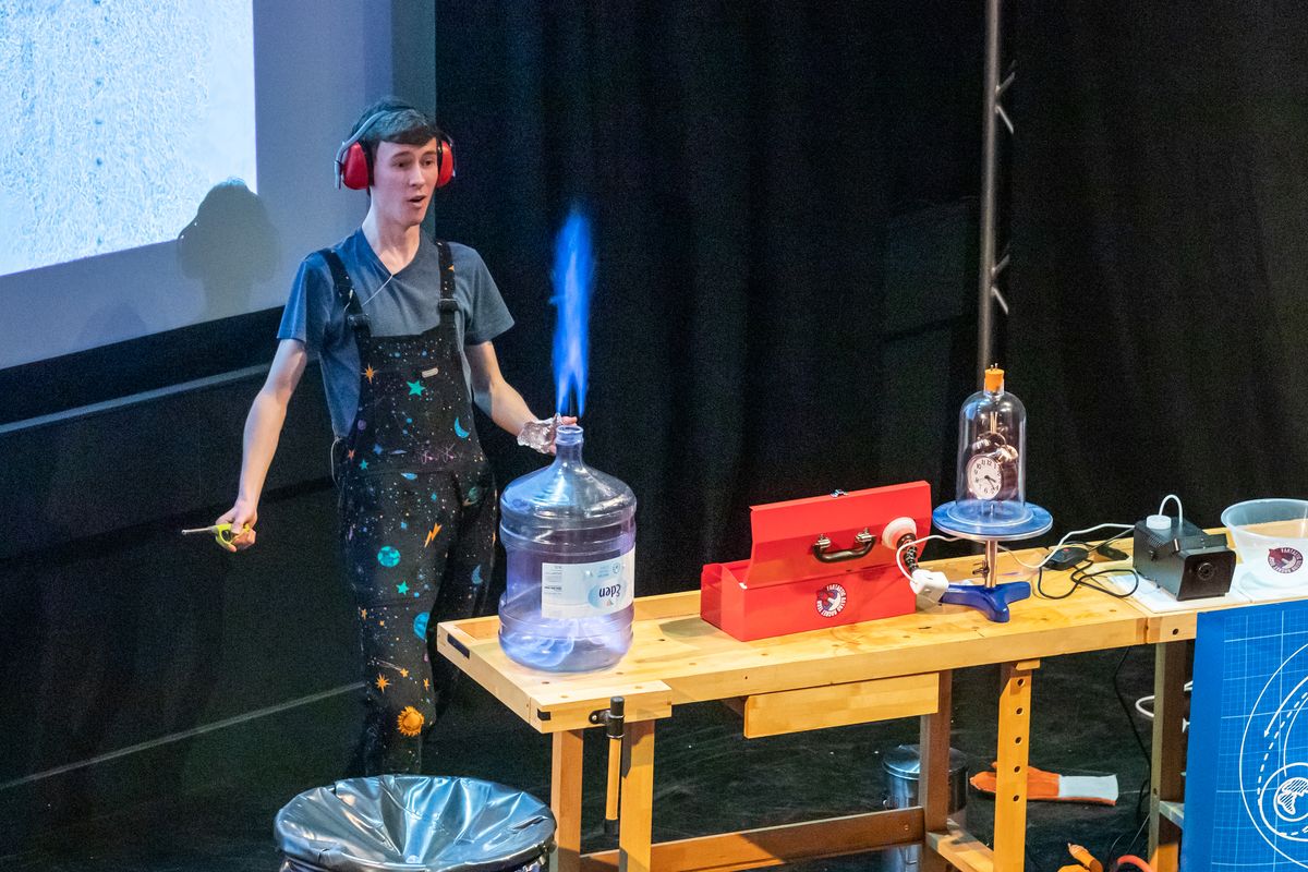 Person carrying out an experiment at a science festival