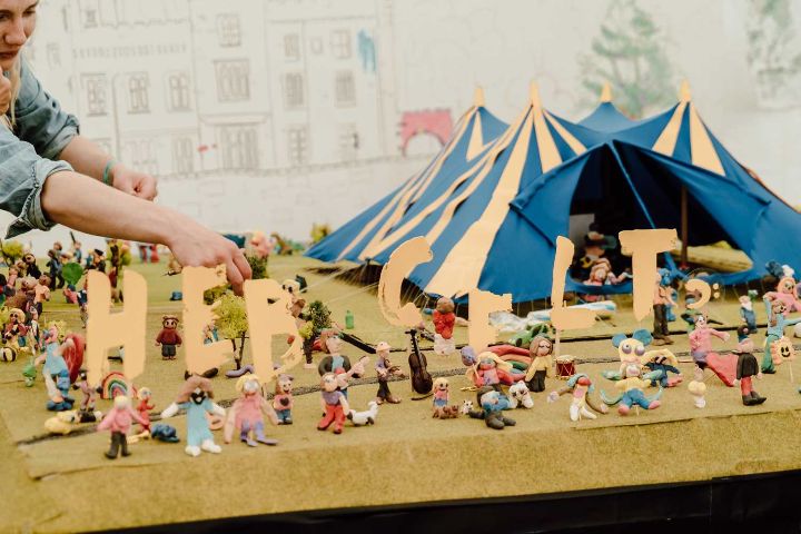 Person making a model of a festival site