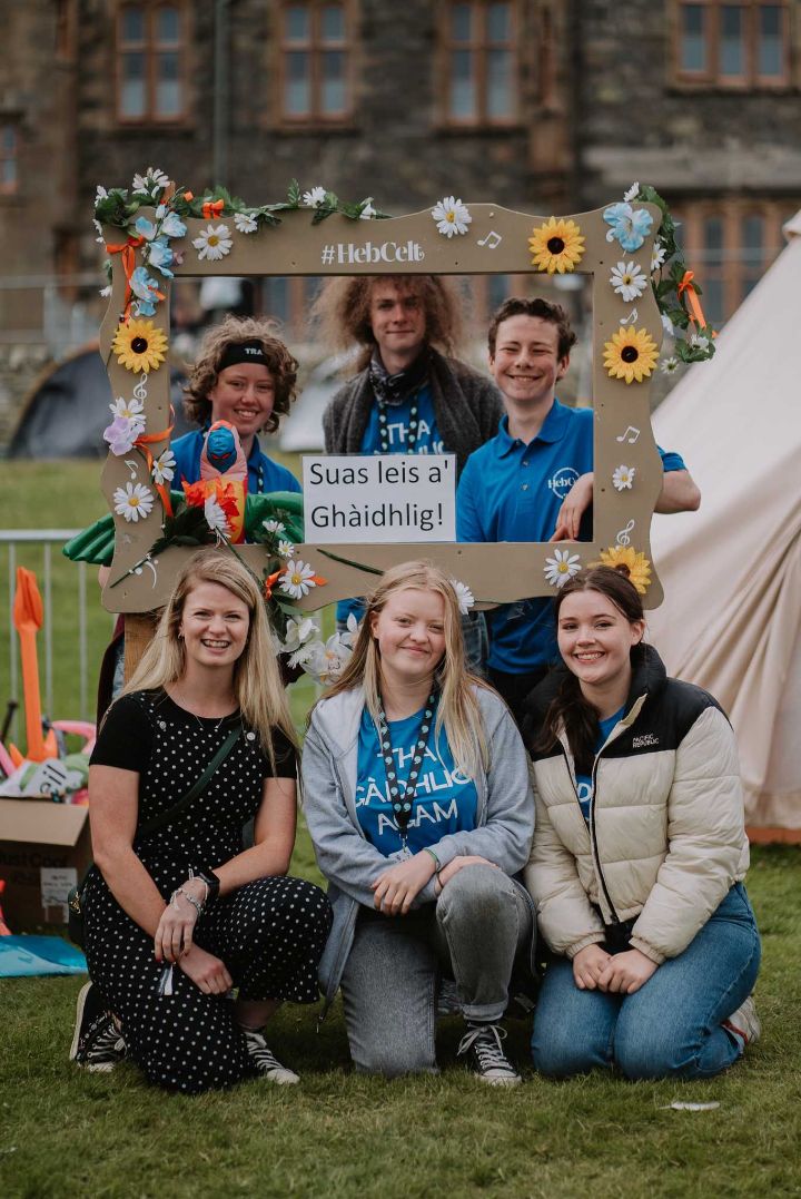 Volunteers posing with a sign at an event