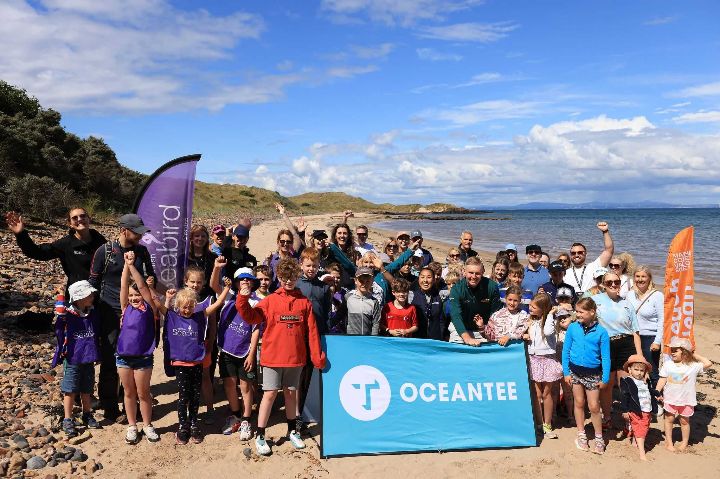 Volunteers posing for a photo during a beach clean