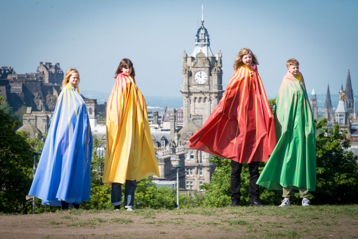 Children in coloured robes on a hill