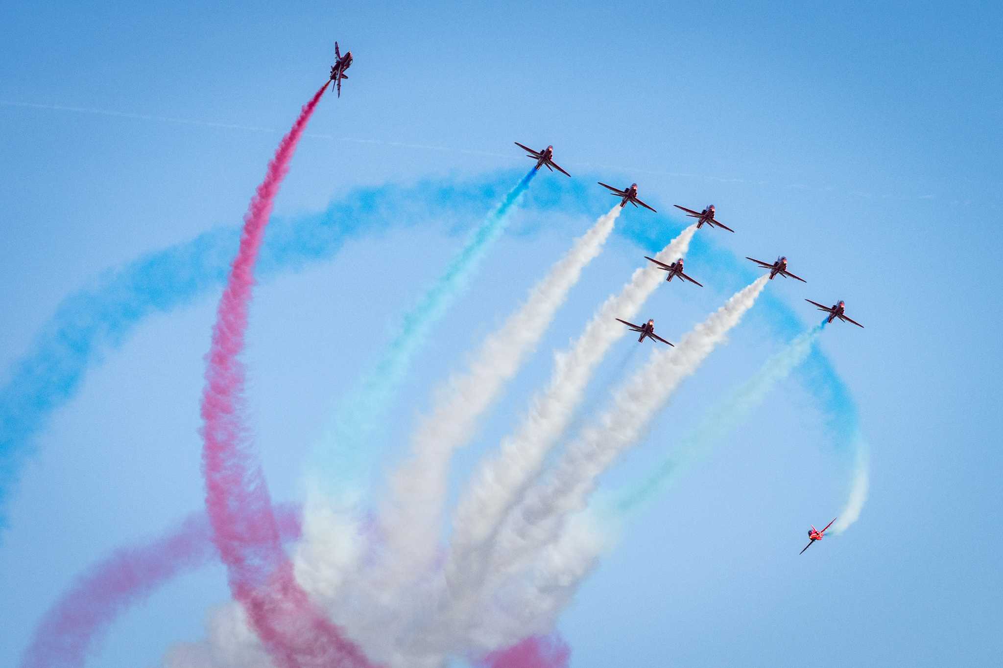 Colourful aerial display with red planes