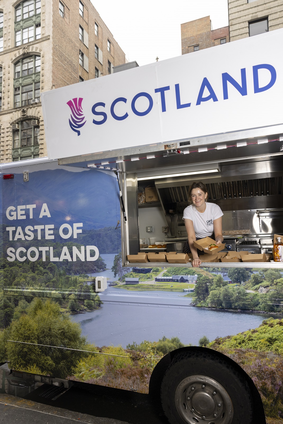 A person  serving Scottish cuisine from Scotland’s Snack Shack.