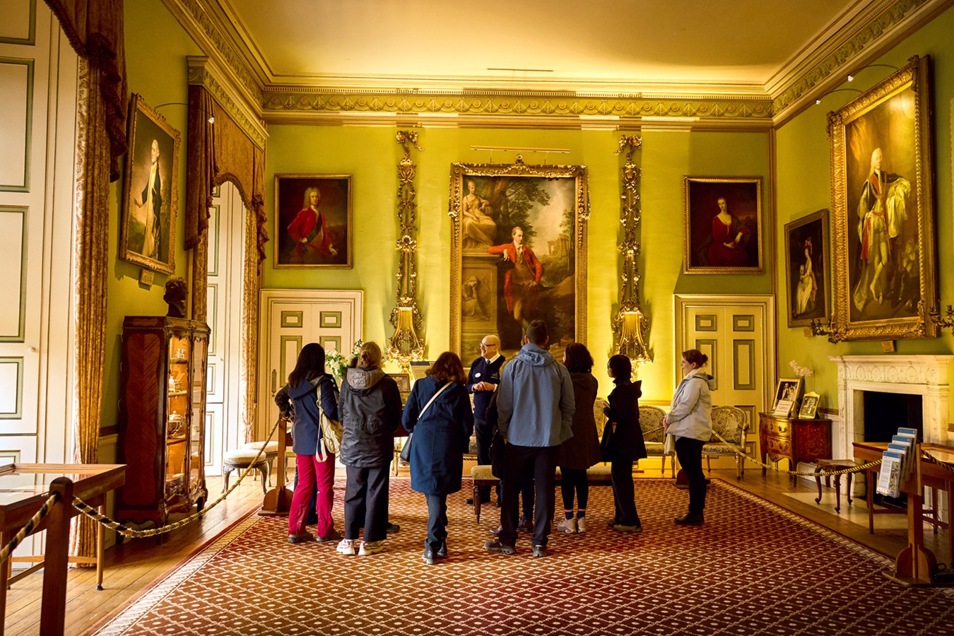 A groups of people taken on a tour around the inside of a castle