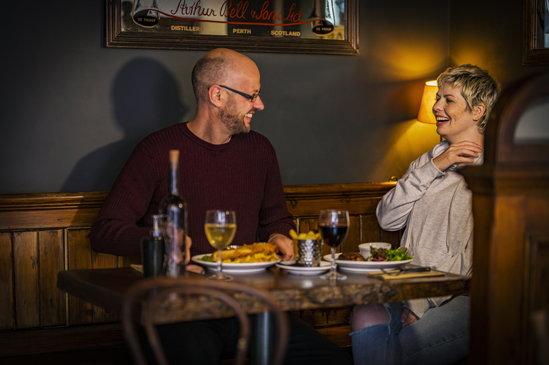 Couple eating at MacGregor's Bar in Inverness