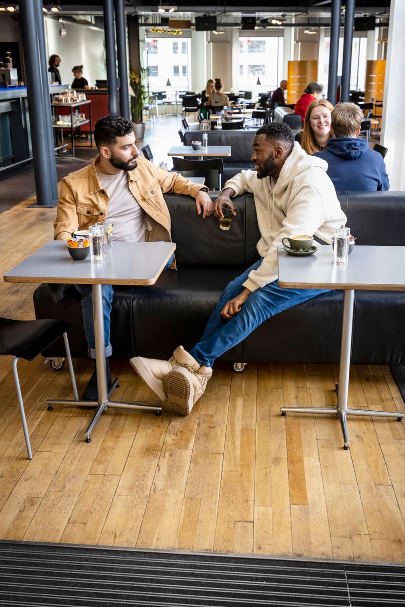 two people sitting in a restaurant together