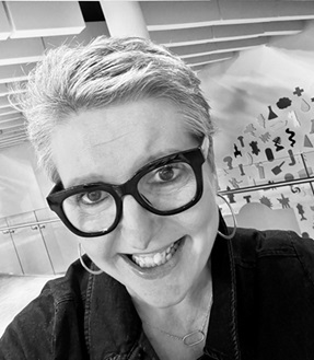 a close up of a person smiling the photo is in black and white