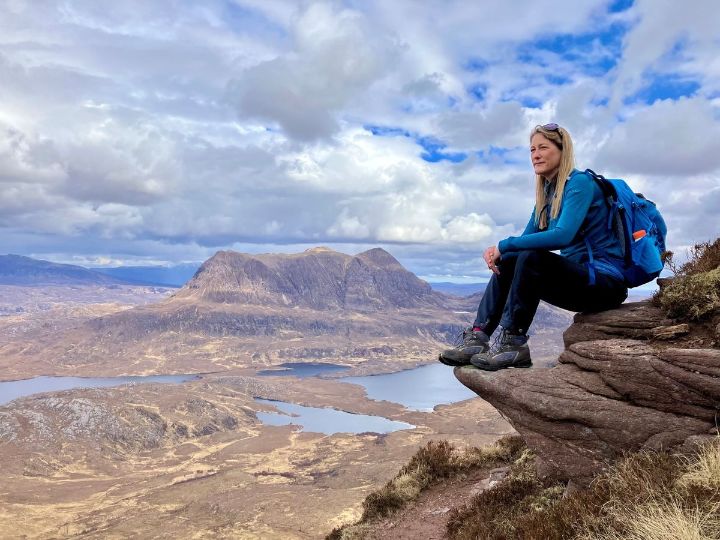 A hiker sitting on top of Stac Pollaidh. Credit: Kim Walton
