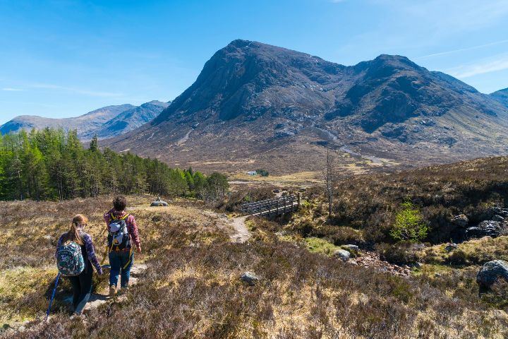 Hillwalkers on the West Highland Way look toward Buachaille Etive Mor