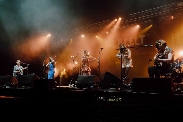 Band performing on stage at a festival