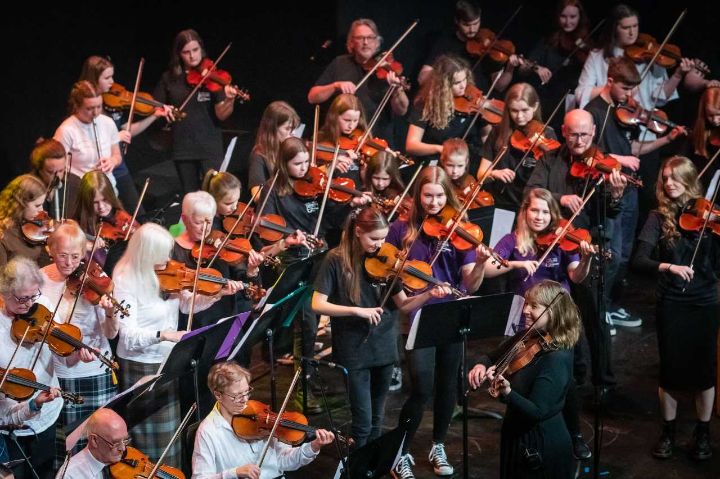 A group of musicians of various ages performing together