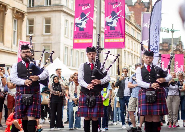 Pipers on Buchanan Street in Glasgow during Piping Live! 2022