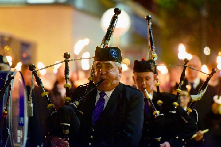 Pipe band marching at night