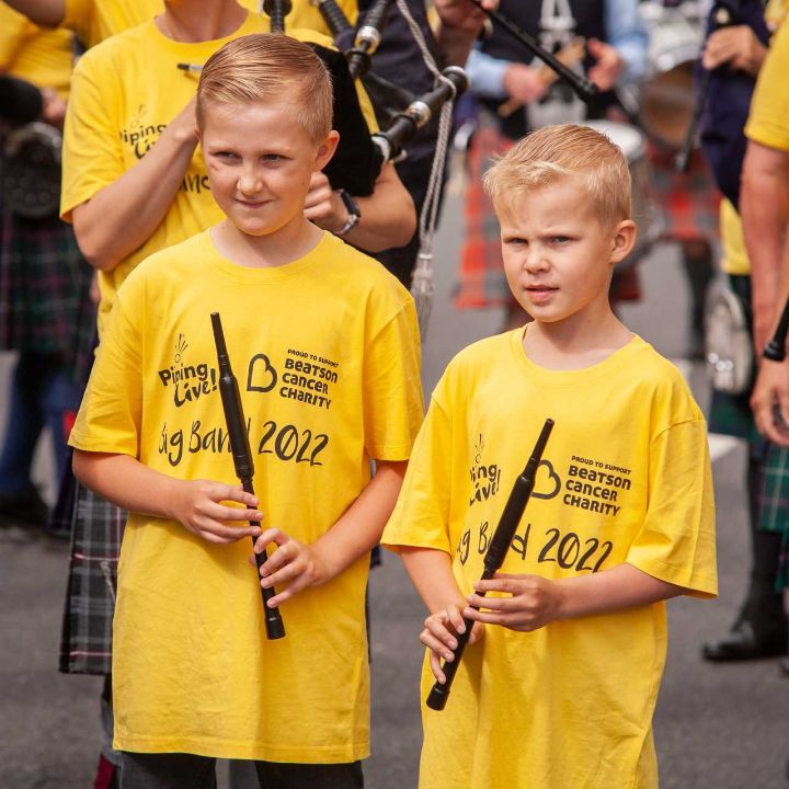 Two young pipers in matching t shirts