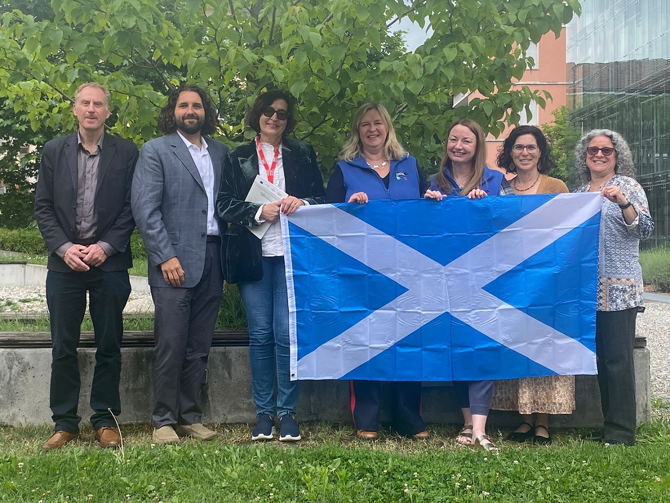 Representatives from Scotland's agritourism sector with international agritourism colleagues holding a Scotland flag.