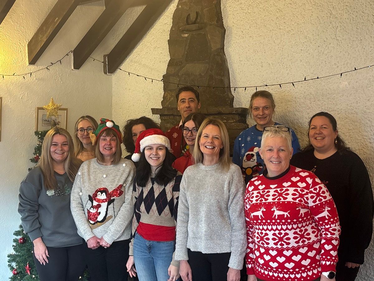 Unique Cottages team celebrating 30th anniversary in Christmas Jumpers