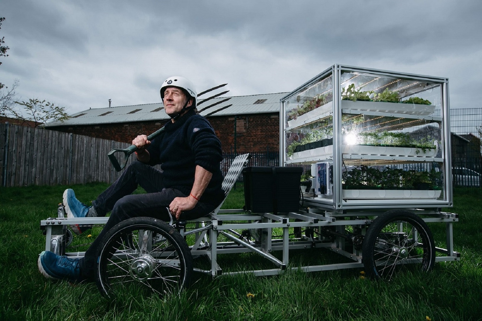 Dandelion Creative Director, Angus Farquhar sits on one of the specially made cargo bikes which carries a musical growing cube