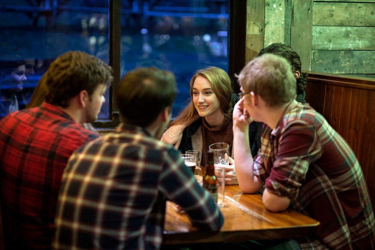 A group of friends together in the Clachaig Inn, Glencoe.