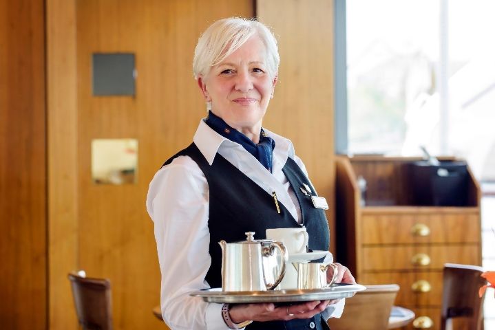 Royal Yacht Britannia member of staff serving tea