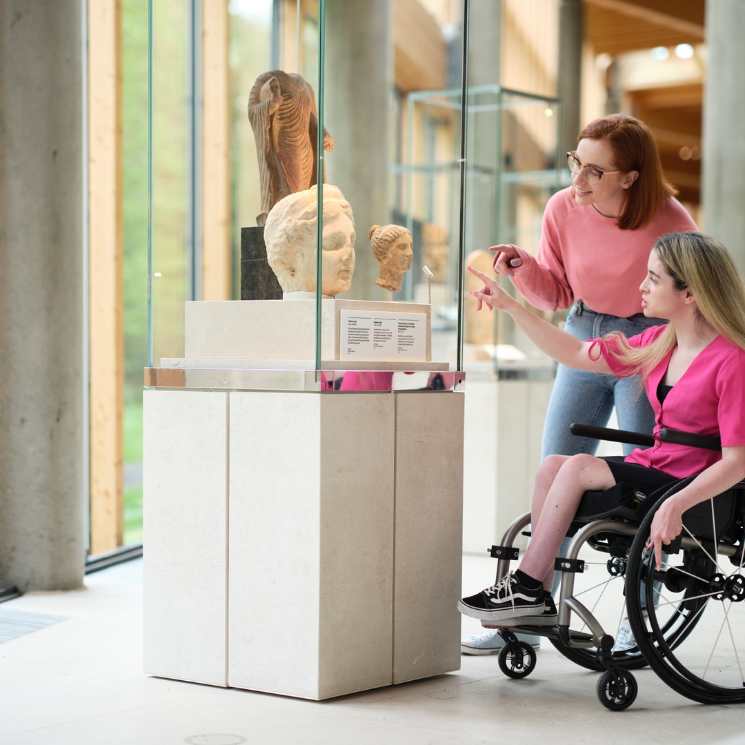 People in a museum looking at a item on display