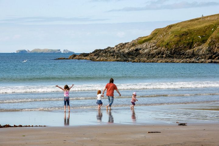 A family at the sandy beach near West Sandwick on Shetland