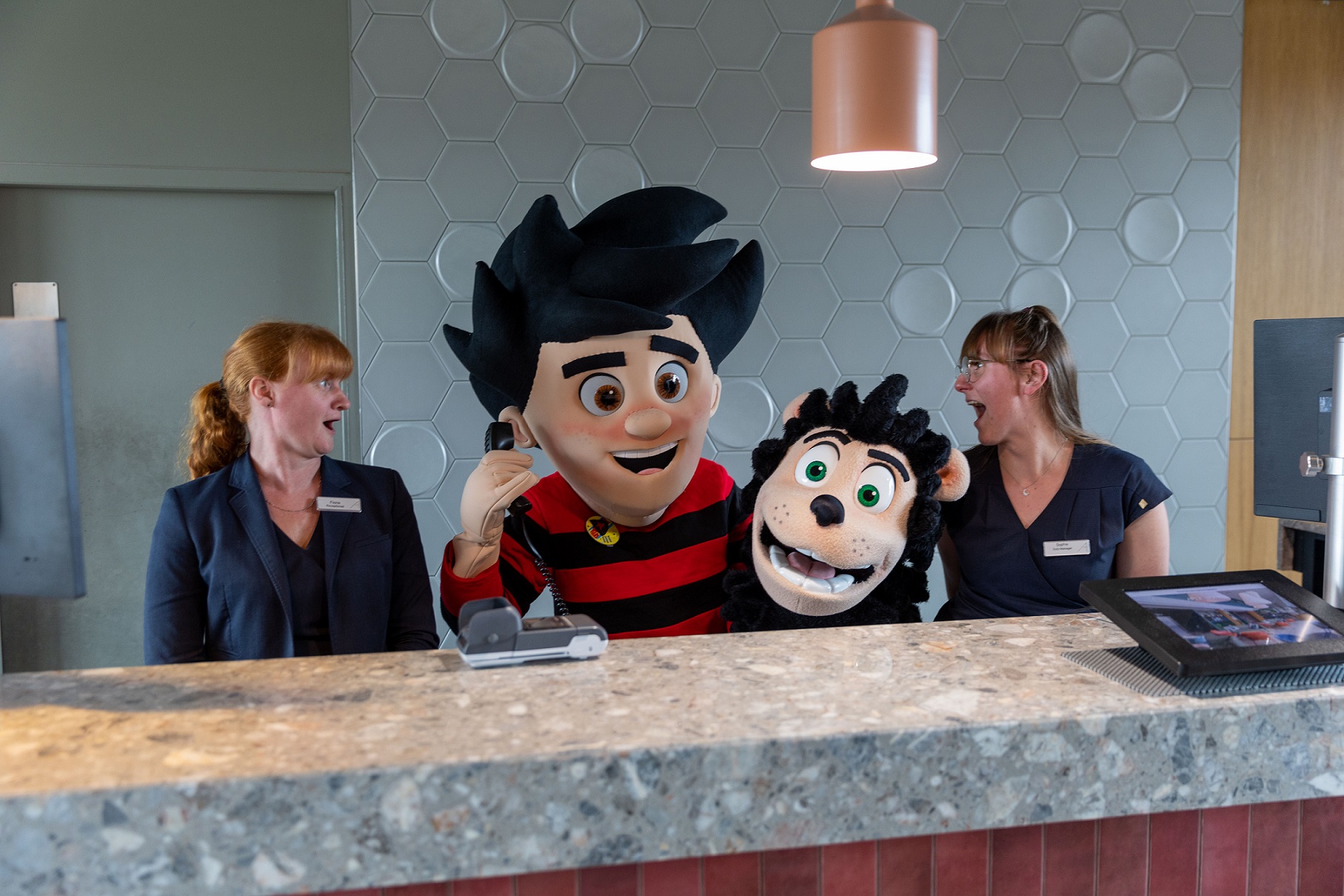 Apex staff with Dennis the Menace and Gnasher answering reception phones