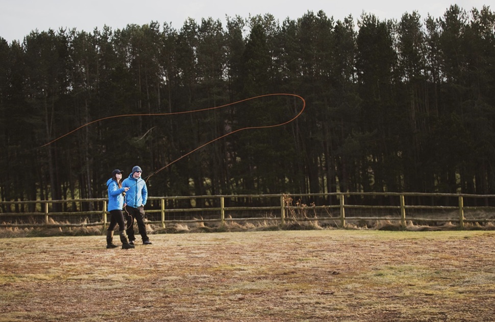 Two people fly fishing