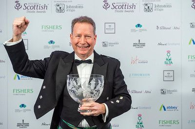 Silver Thistle award winner celebrates with trophy