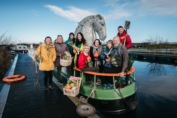 People on a canal boat in front of the Kelpies
