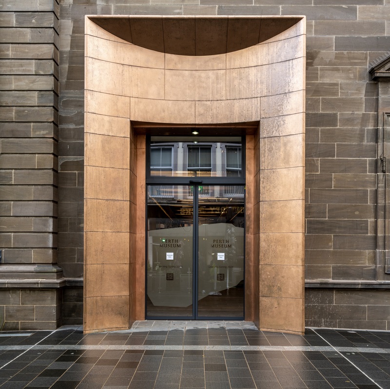 A large outside door to a museum